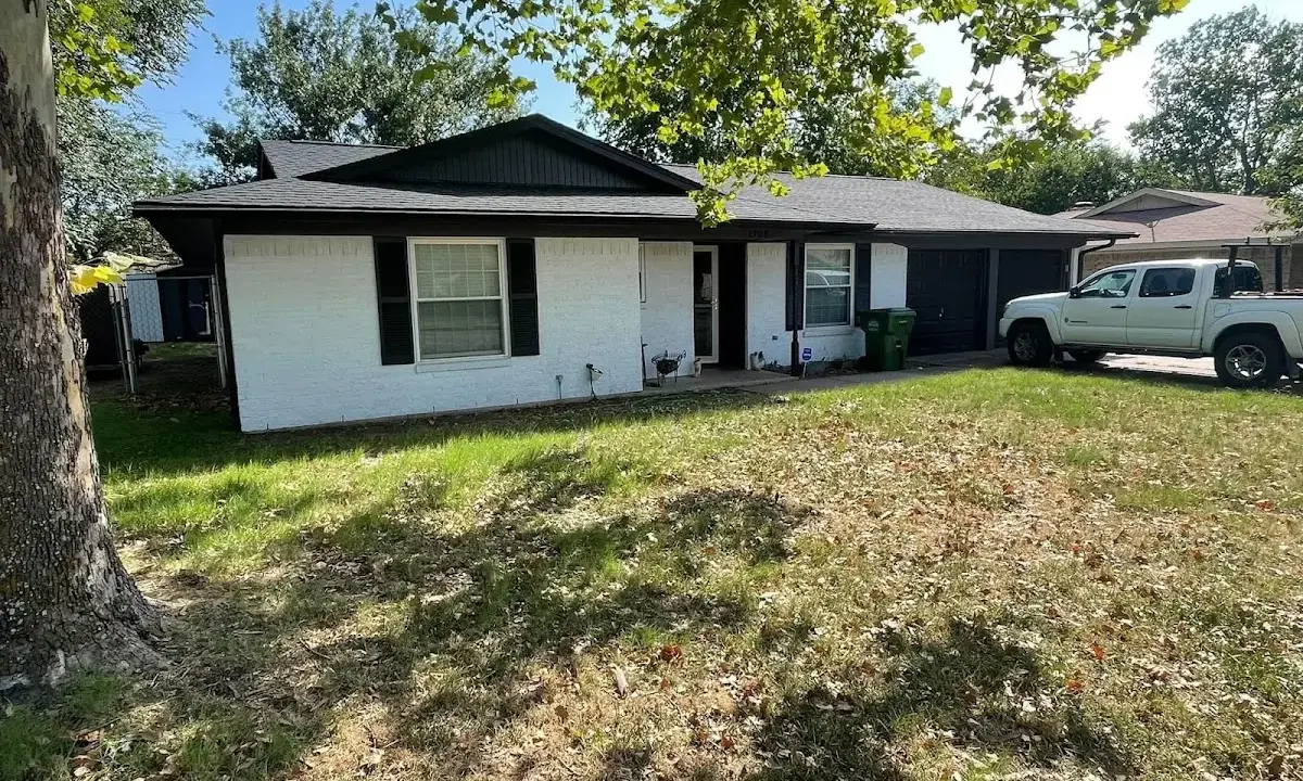 Professional roofing crew working on a residential roof in Van Buren